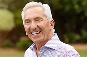 Happy senior man enjoying the benefits of All-on-4 treatment