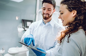 Dentist and patient discussing cost of dental bridges