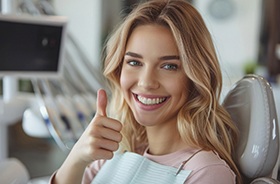 Happy dental patient making thumbs-up gesture