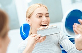 Woman looking at smile in mirror