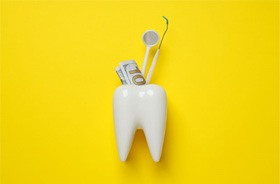 Tooth model with dental instruments and money