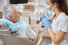 Dentist and patient talking in treatment room