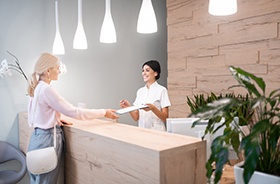 Dental patient learning about her options for paying for treatment