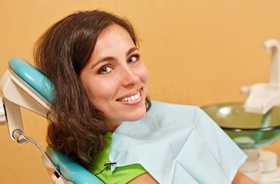 Female patient smiling after successful dental implant salvage treatment