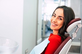 Female patient smiling after successful dental implant salvage