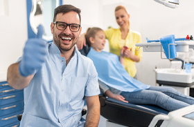 Smiling family dentist in Hamden giving thumbs up