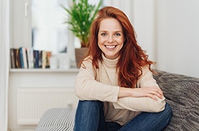 Smiling woman who practices proper dental implant care in Hamden