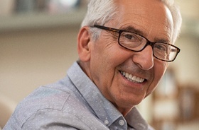 Senior man enjoying the benefits of implant dentures