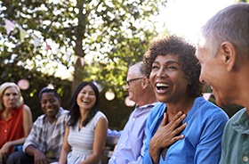 Diverse group of friends with dental implants in Hamden laughing together