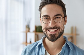 young man with dental implants in Hamden smiling