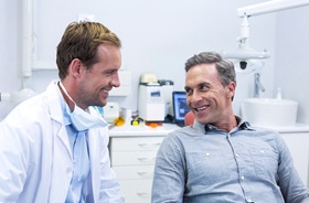 Dentist and patient discussing dental implant candidacy requirements