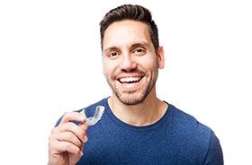 Man holding an Invisalign tray