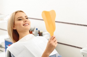 happy dental patient with mirror