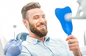 Man looking at smile in mirror