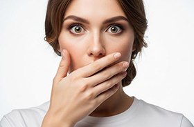 Concerned woman covering her mouth