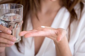 woman preparing to swallow oral conscious sedation medication