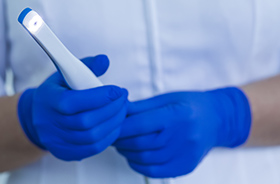 Dentist holding intraoral camera