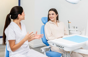 Dentist and patient talking during friendly consultation