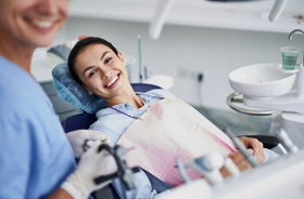 Happy dental patient in treatment chair