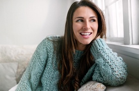 Smiling woman with straight teeth after having braces