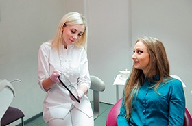 Dental patient and dental team member discussing treatment plan