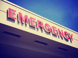 red emergency room sign against blue sky background