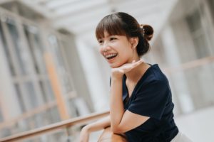 Smiling woman, happy she could afford the cost of orthodontic treatment in Hamden