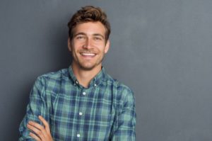 Smiling man, happy with his decision to undergo a root canal in Hamden