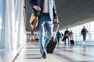 Man walking through airport with his suitcase