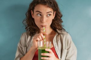 Woman sipping a smoothie through a straw