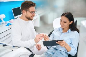 Dental patient preparing to sign paperwork