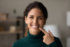 Happy woman pointing at her teeth