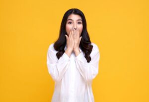 Shocked woman covering her mouth