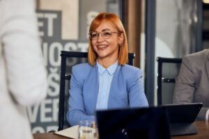 Woman with braces speaking to colleagues in a professional setting