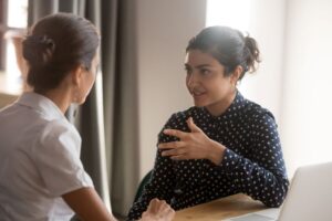 Two women conversing in a professional setting