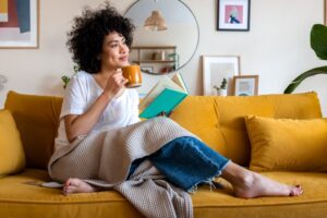 Woman reading a book and drinking coffee
