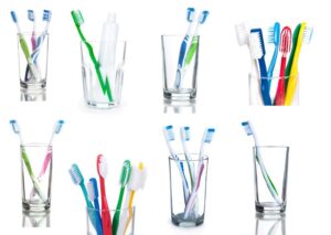 Variety of toothbrushes in clear glasses 